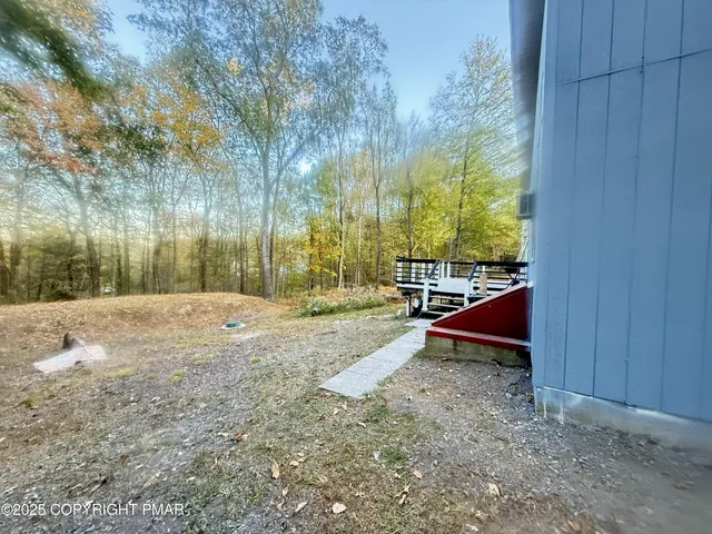 a view of yard with tree and wooden fence