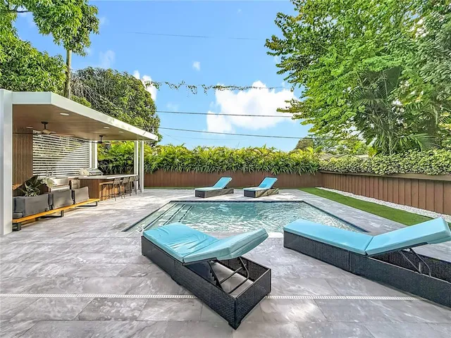 a view of a patio with table and chairs potted plants with wooden floor