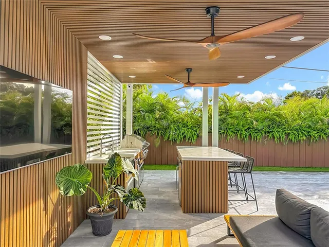 an aerial view of residential houses with outdoor space and trees