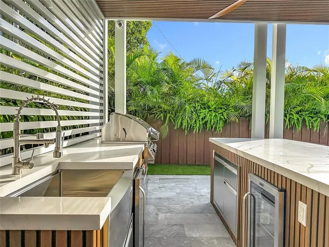 an aerial view of residential houses with outdoor space and trees