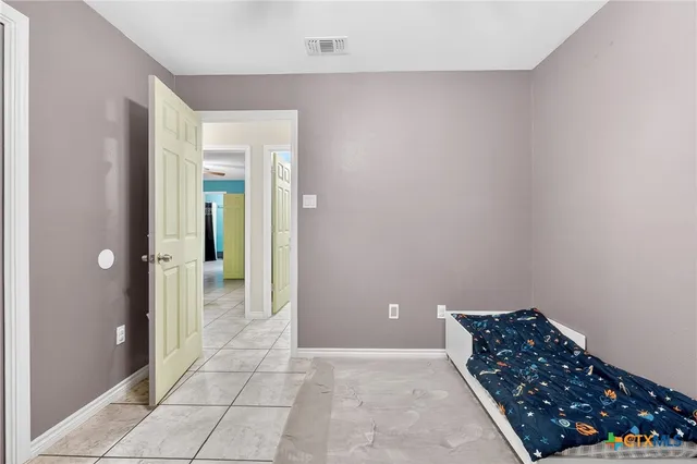 a bedroom with furniture and a window