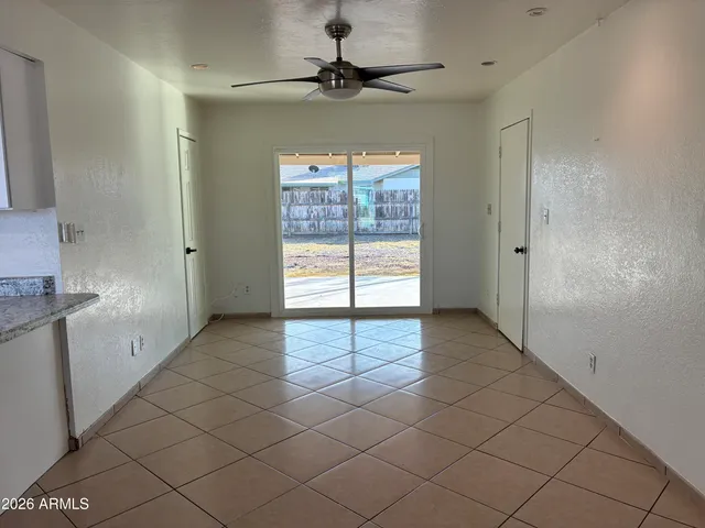 an empty room with windows and chandelier