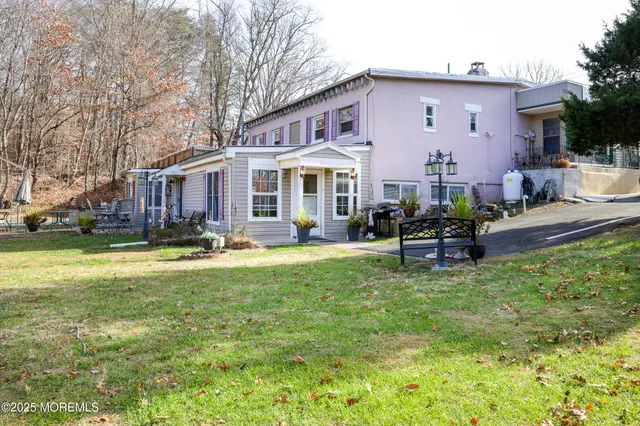 a view of a house with swimming pool and sitting area