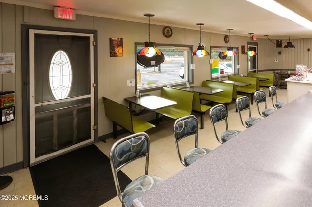 a view of a dining room with furniture and chandelier