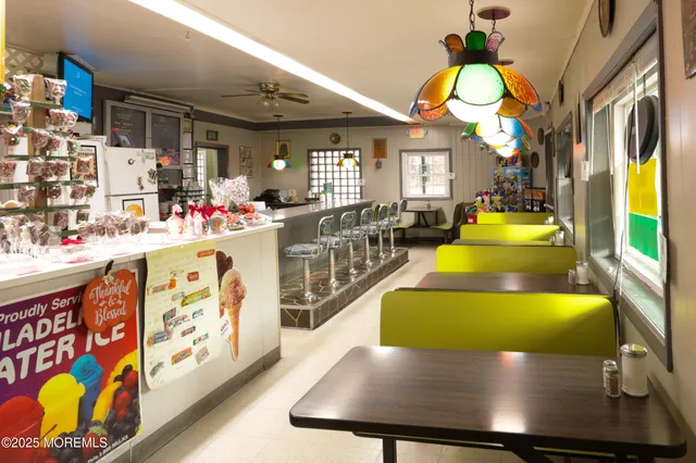 a kitchen with stainless steel appliances kitchen island granite countertop a stove a sink and a dining table