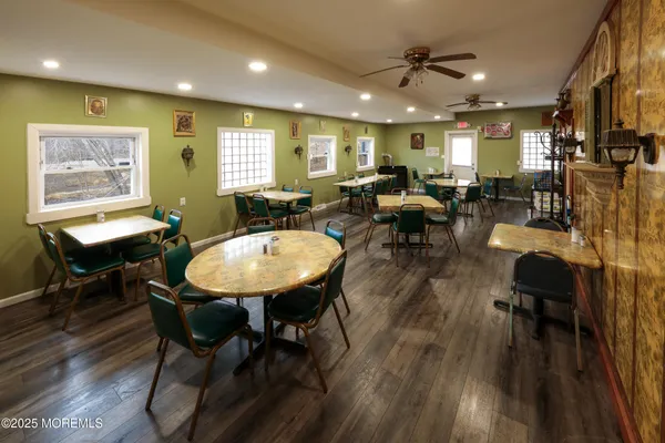 a view of a a dining room with furniture window and wooden floor