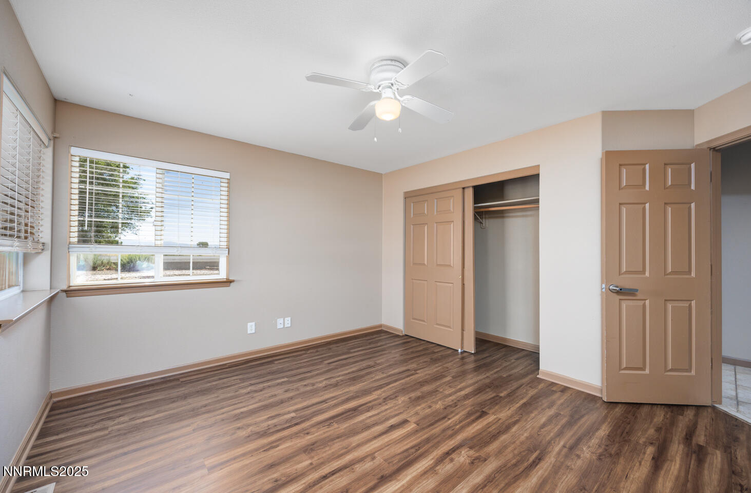 305 Cemetery Road Fallon, NV 89406 - Photo 12 of 26 a view of an empty room with wooden floor and a window
