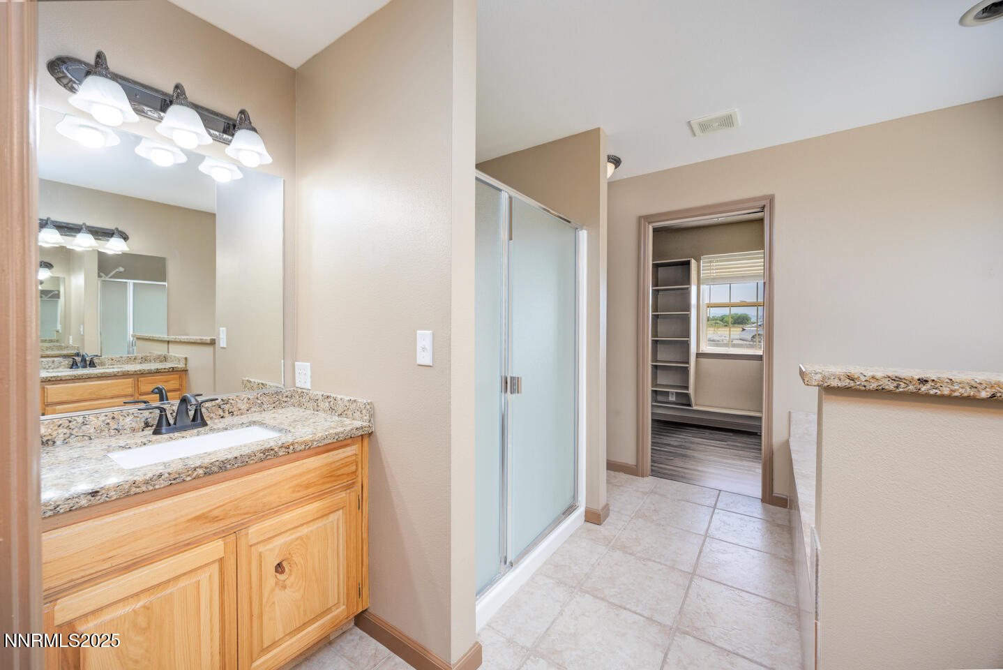 305 Cemetery Road Fallon, NV 89406 - Photo 18 of 26 a bathroom with a granite countertop sink a mirror and a shower