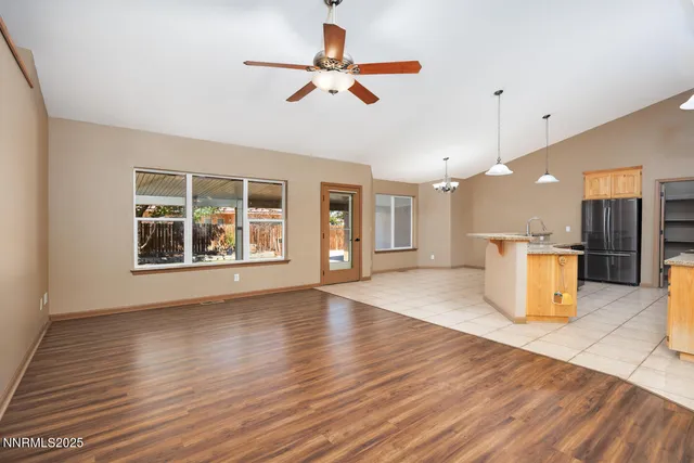 a view of an empty room with a kitchen