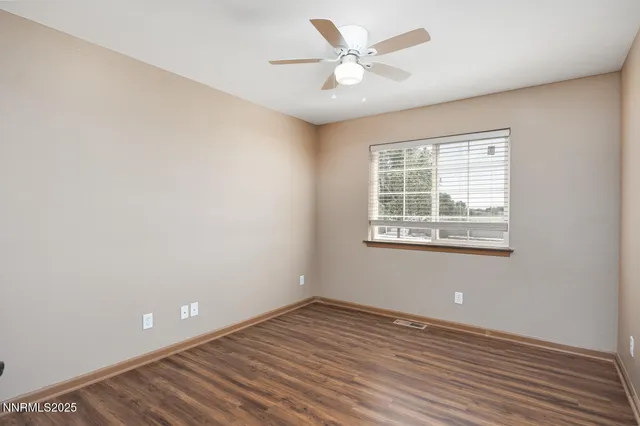 a bathroom with a granite countertop sink toilet and mirror