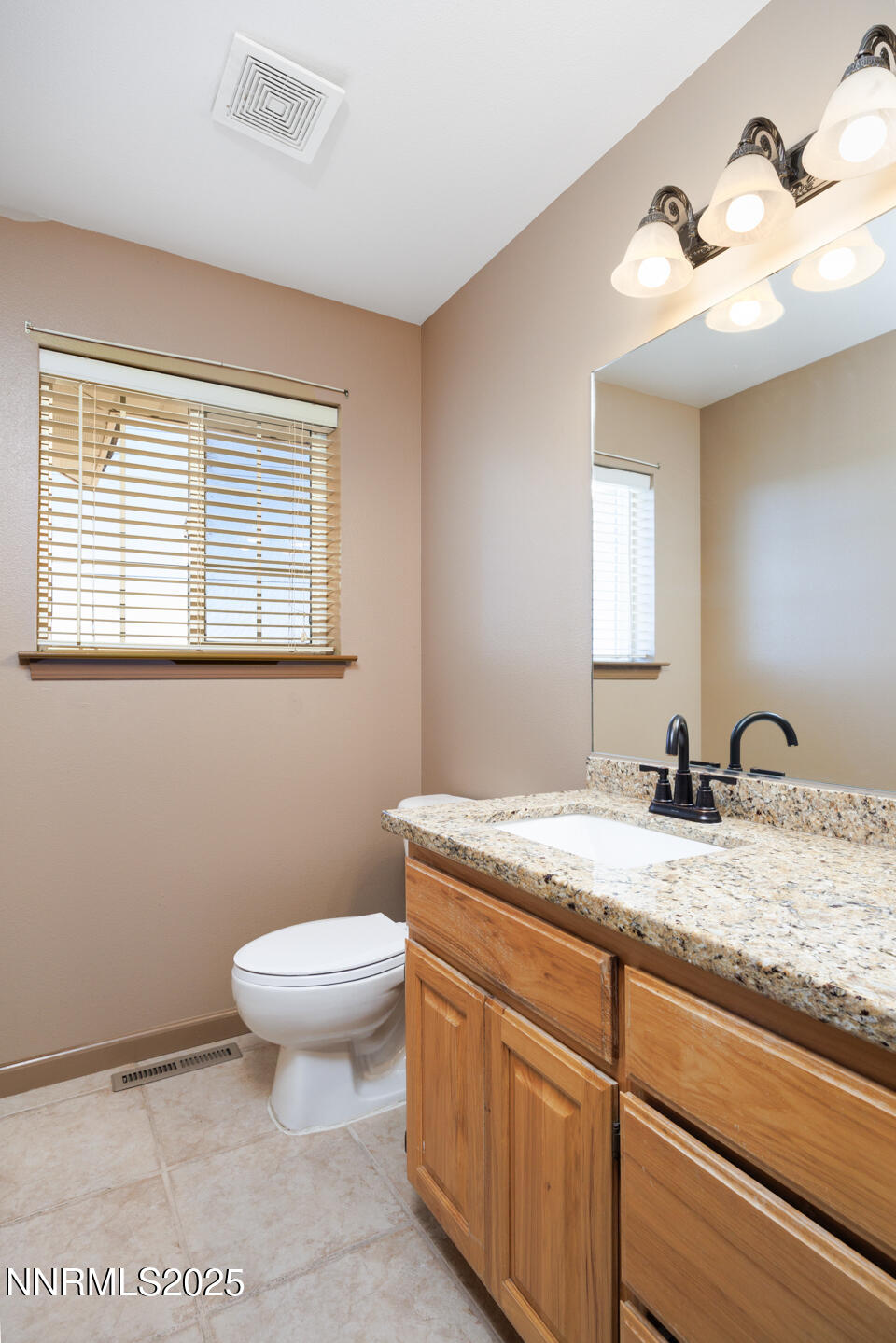 305 Cemetery Road Fallon, NV 89406 - Photo 10 of 26 a bathroom with a granite countertop sink toilet and mirror