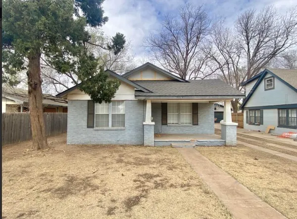 a house that has a tree in front of it