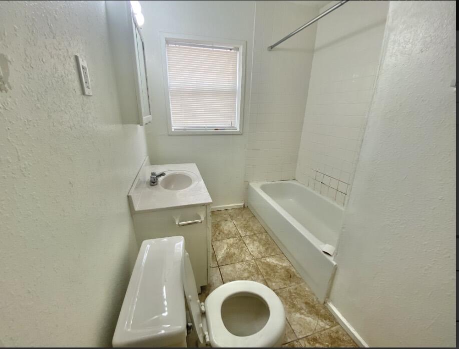 2114 27th Street Lubbock, TX 79411 - Photo 6 of 9 a bathroom with a sink and toilet