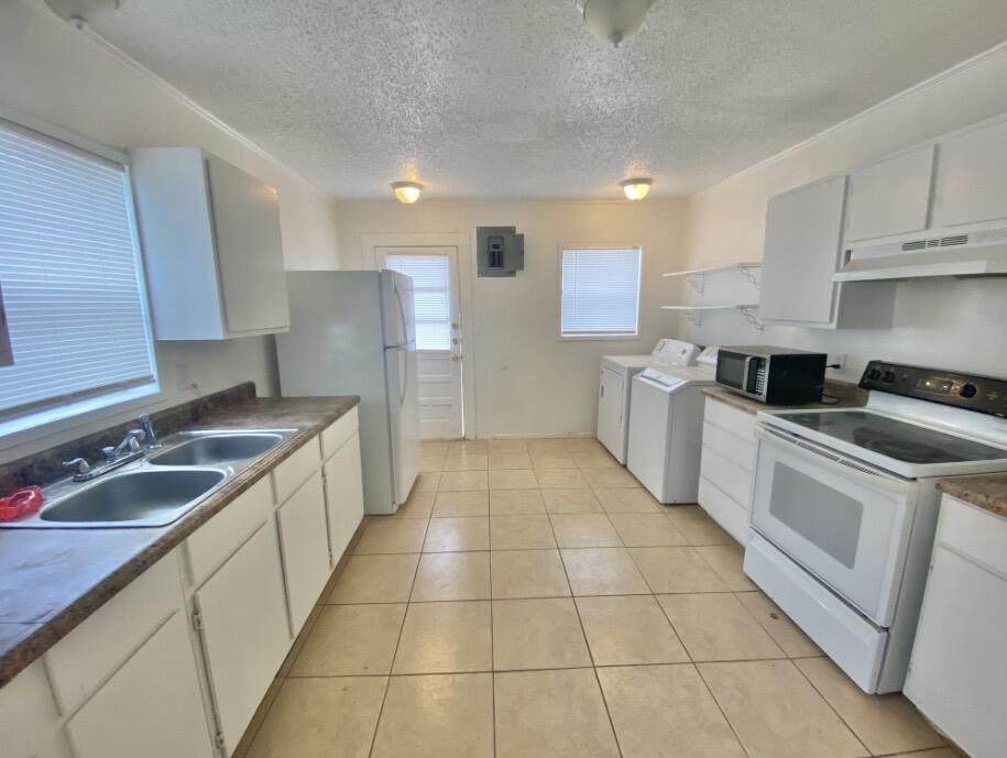 2114 27th Street Lubbock, TX 79411 - Photo 8 of 9 a kitchen with a sink a stove top oven and cabinets