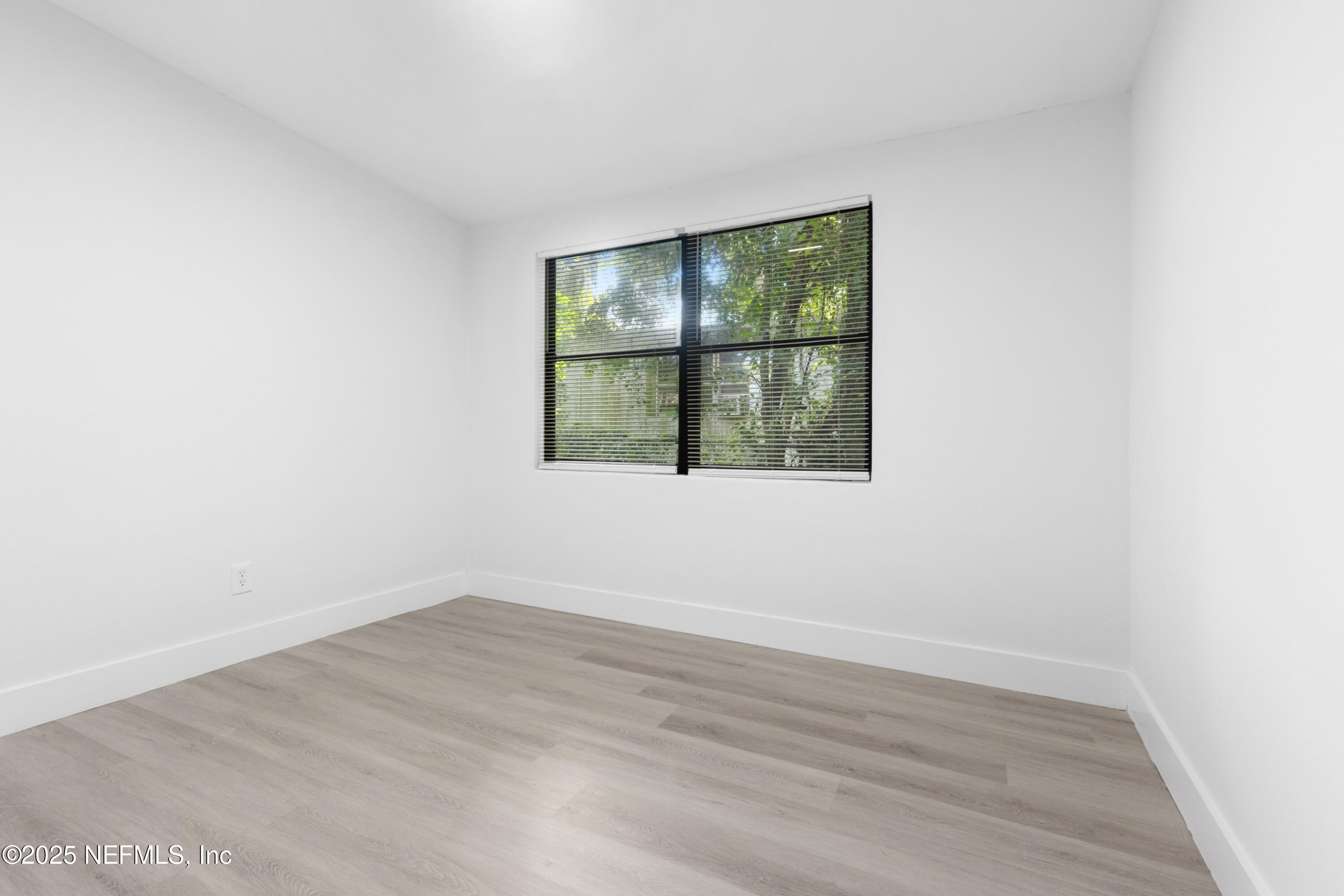 9166 3rd Avenue Jacksonville, FL 32208 - Photo 16 of 23 an empty room with wooden floor and windows