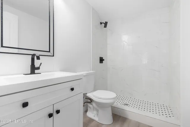 a bathroom with a sink a toilet and mirror