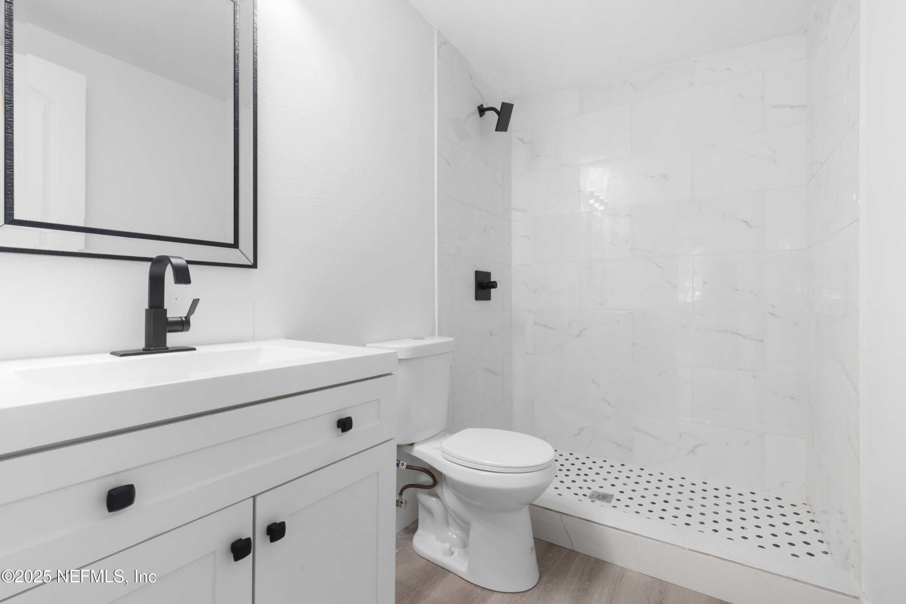 9166 3rd Avenue Jacksonville, FL 32208 - Photo 18 of 23 a bathroom with a sink a toilet and mirror