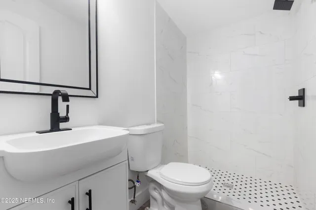 a bathroom with a sink toilet and mirror