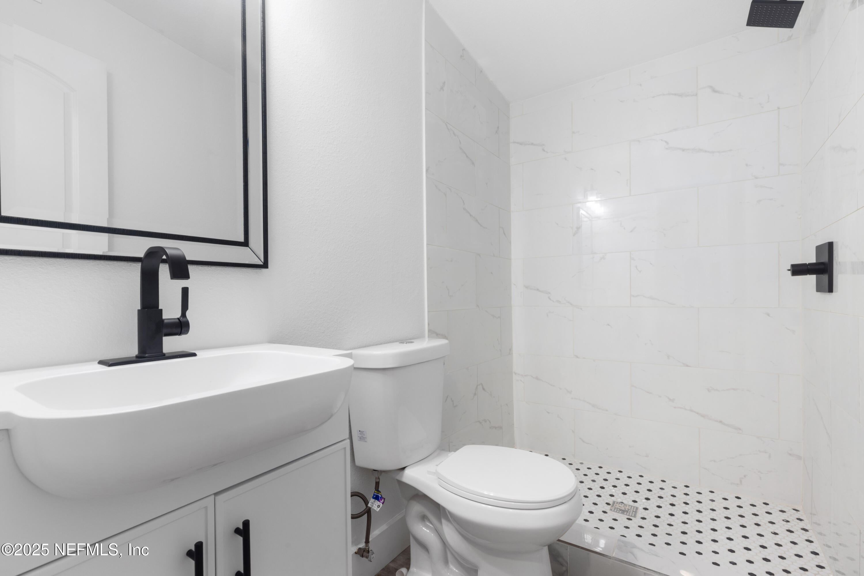 9166 3rd Avenue Jacksonville, FL 32208 - Photo 19 of 23 a bathroom with a sink toilet and mirror