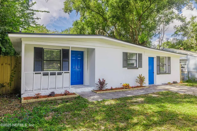 a front view of a house with a yard