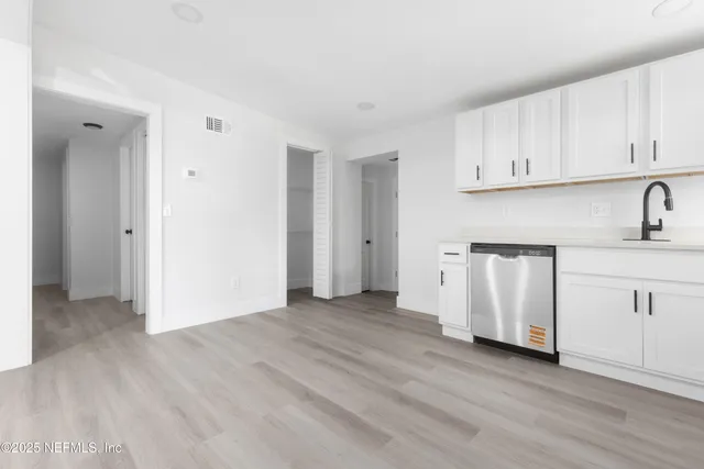 a view of a kitchen with wooden floor