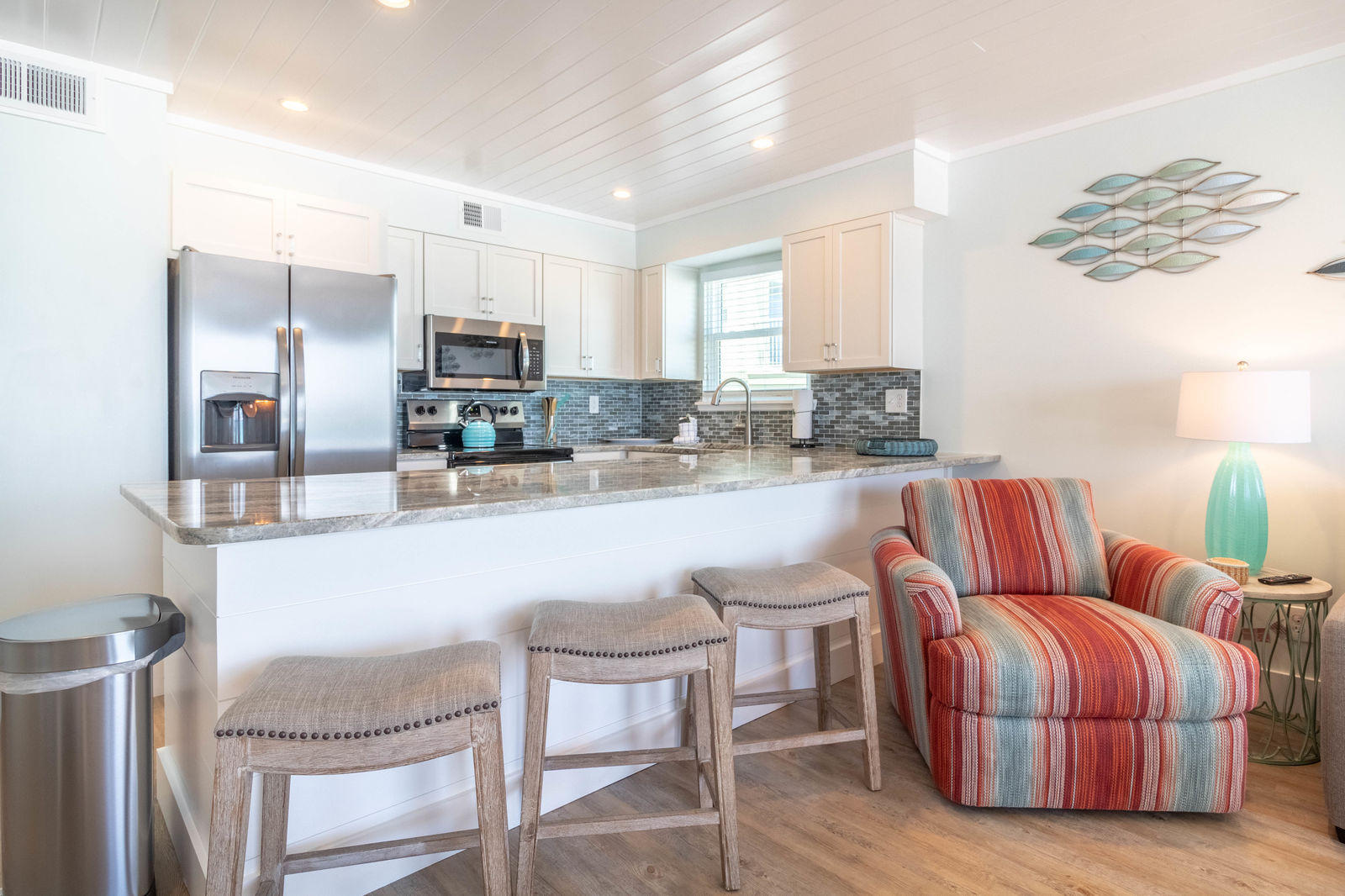595 Eastern Lake Road, Unit 206 Santa Rosa Beach, FL 32459 - Photo 12 of 33 a kitchen with stainless steel appliances granite countertop a kitchen island a stove a sink a dining table and chairs