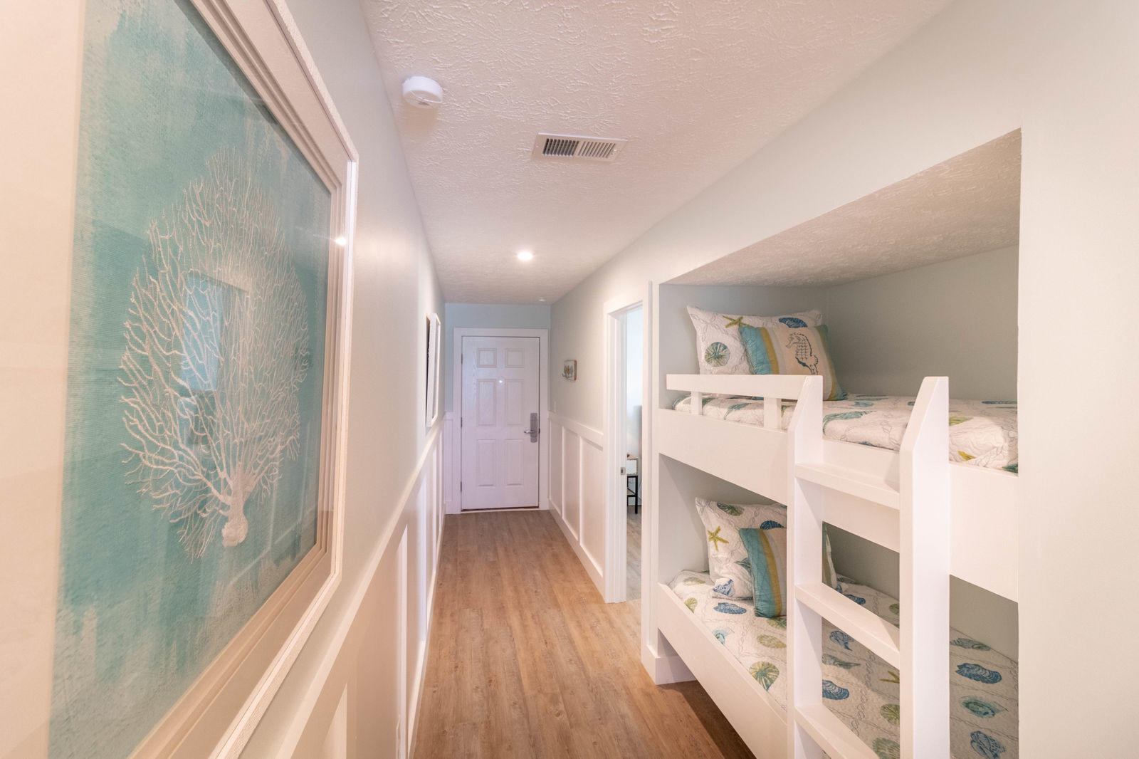 595 Eastern Lake Road, Unit 206 Santa Rosa Beach, FL 32459 - Photo 20 of 33 a view of a hallway with wooden floor and staircase