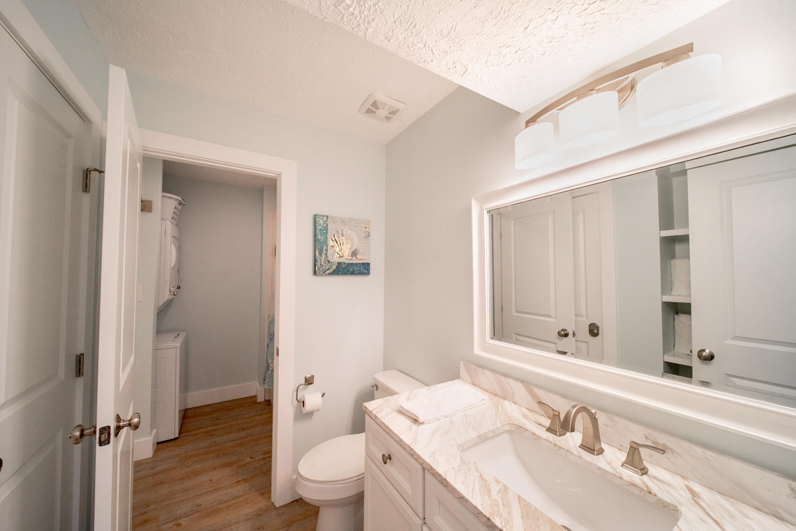 595 Eastern Lake Road, Unit 206 Santa Rosa Beach, FL 32459 - Photo 27 of 33 a bathroom with a granite countertop sink a toilet and a large mirror