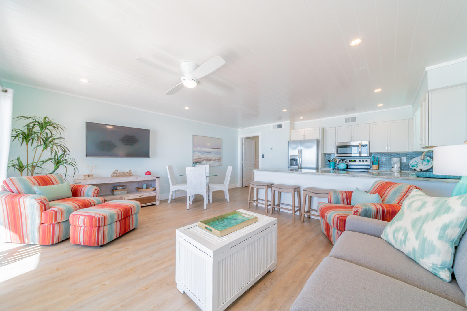595 Eastern Lake Road, Unit 206 Santa Rosa Beach, FL 32459 - Photo 6 of 33 a living room with furniture kitchen view and a flat screen tv