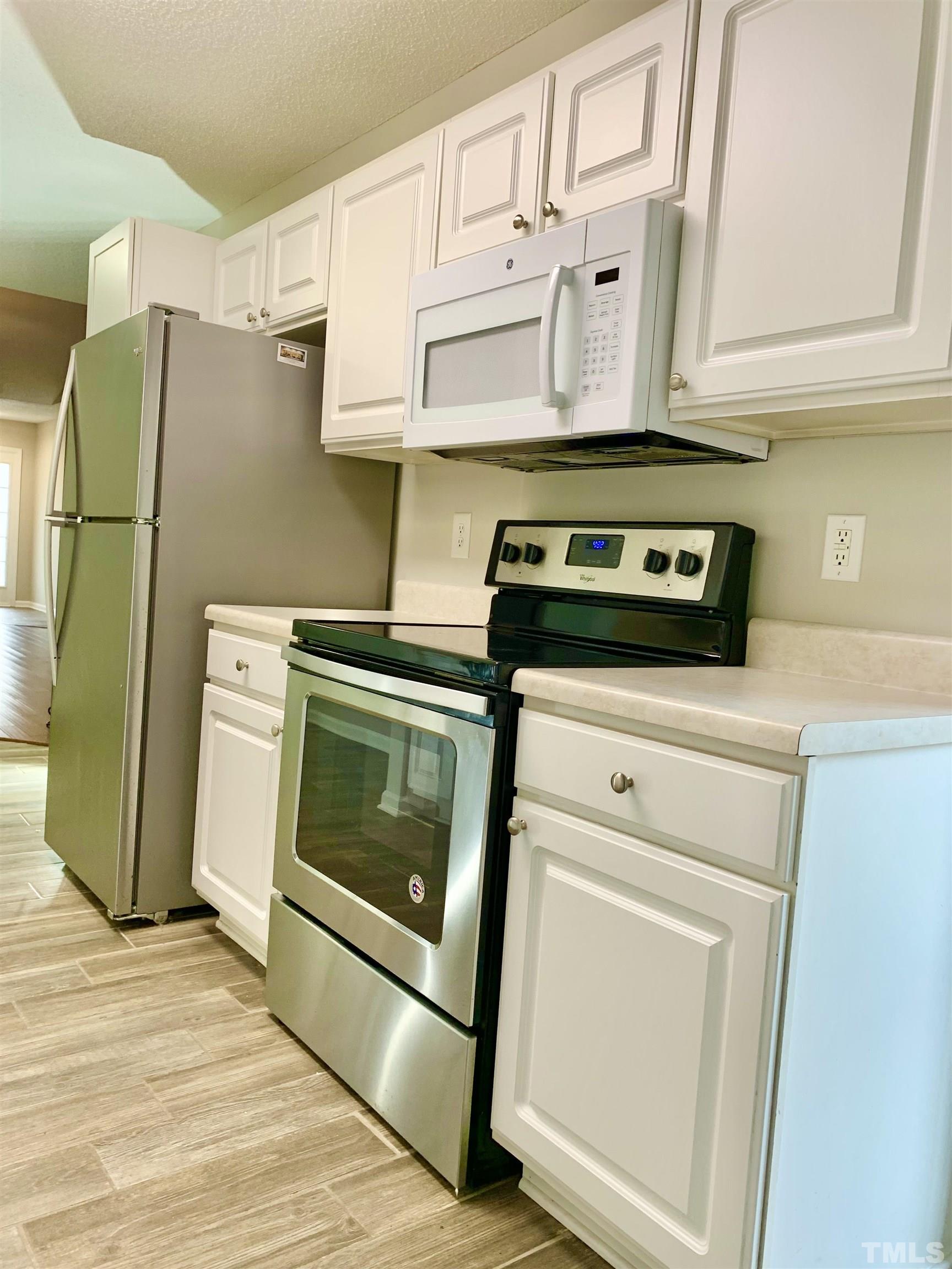 11320 Clubhaven Place, Unit 102 Raleigh, NC 27617 - Photo 12 of 15 a stove top oven sitting inside of a kitchen