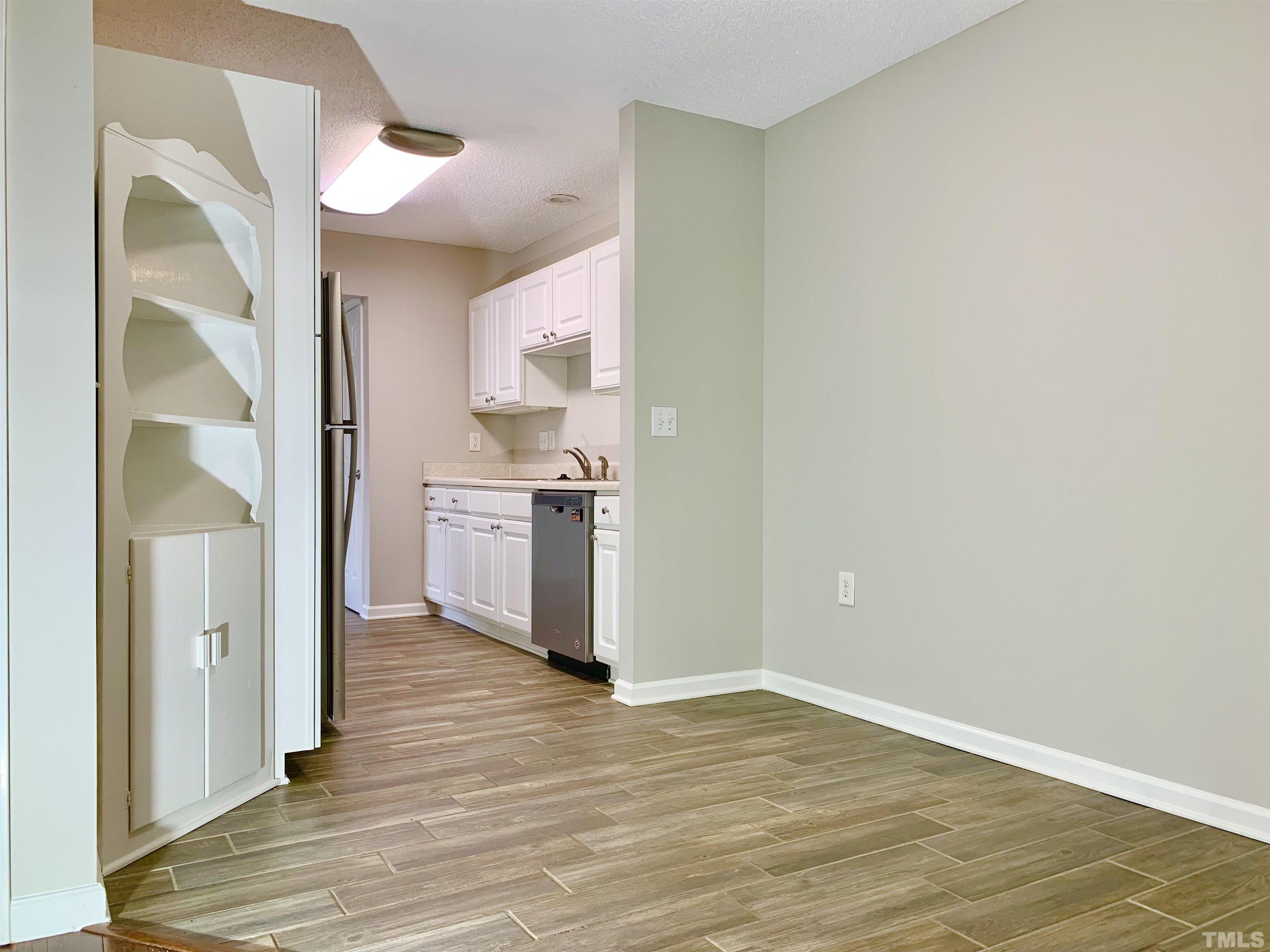 11320 Clubhaven Place, Unit 102 Raleigh, NC 27617 - Photo 9 of 15 a view of a kitchen cabinets and wooden floor
