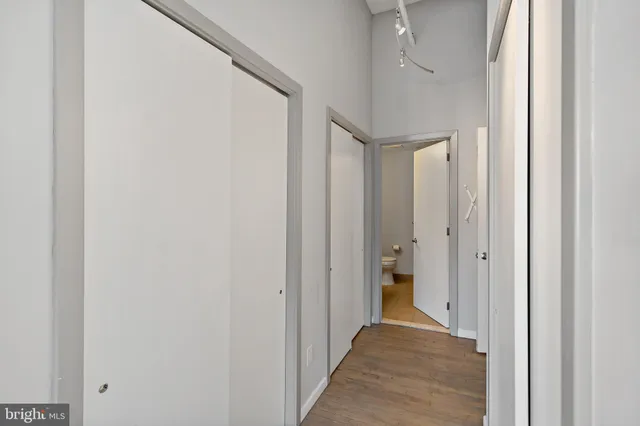 a view of a hallway with wooden floor