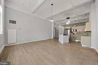 a view of a kitchen with a sink and a refrigerator