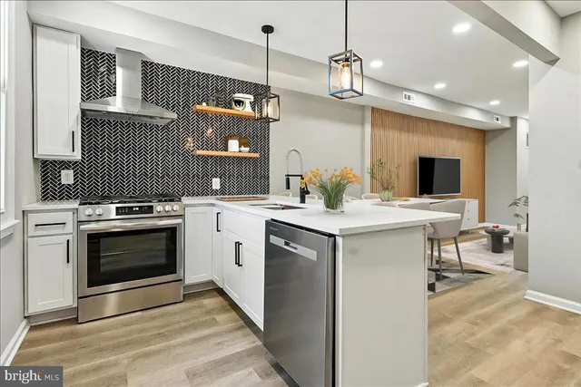 a kitchen with a sink stove and microwave