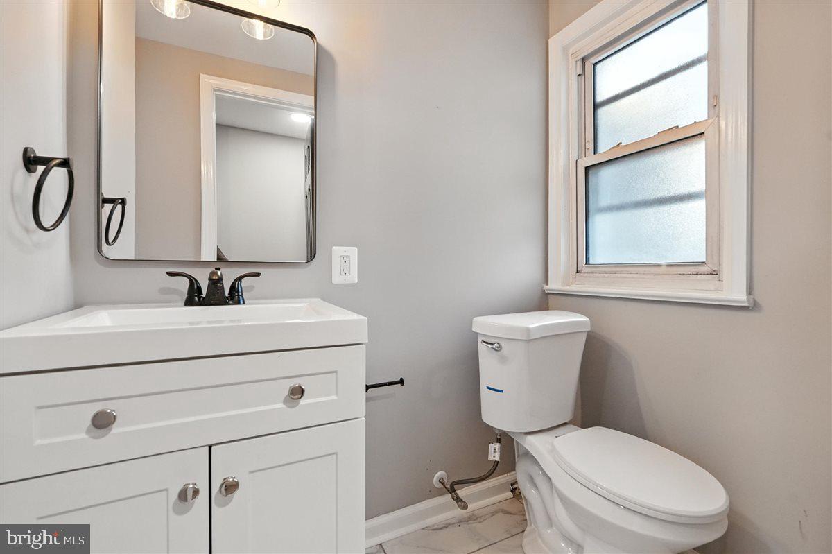 2613 Franklin Street Northeast Washington, DC 20018 - Photo 22 of 29 a bathroom with a toilet sink vanity and mirror