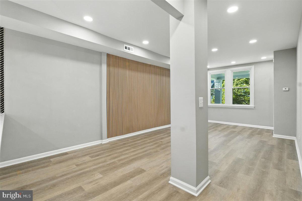 2613 Franklin Street Northeast Washington, DC 20018 - Photo 9 of 29 an empty room with wooden floor and windows