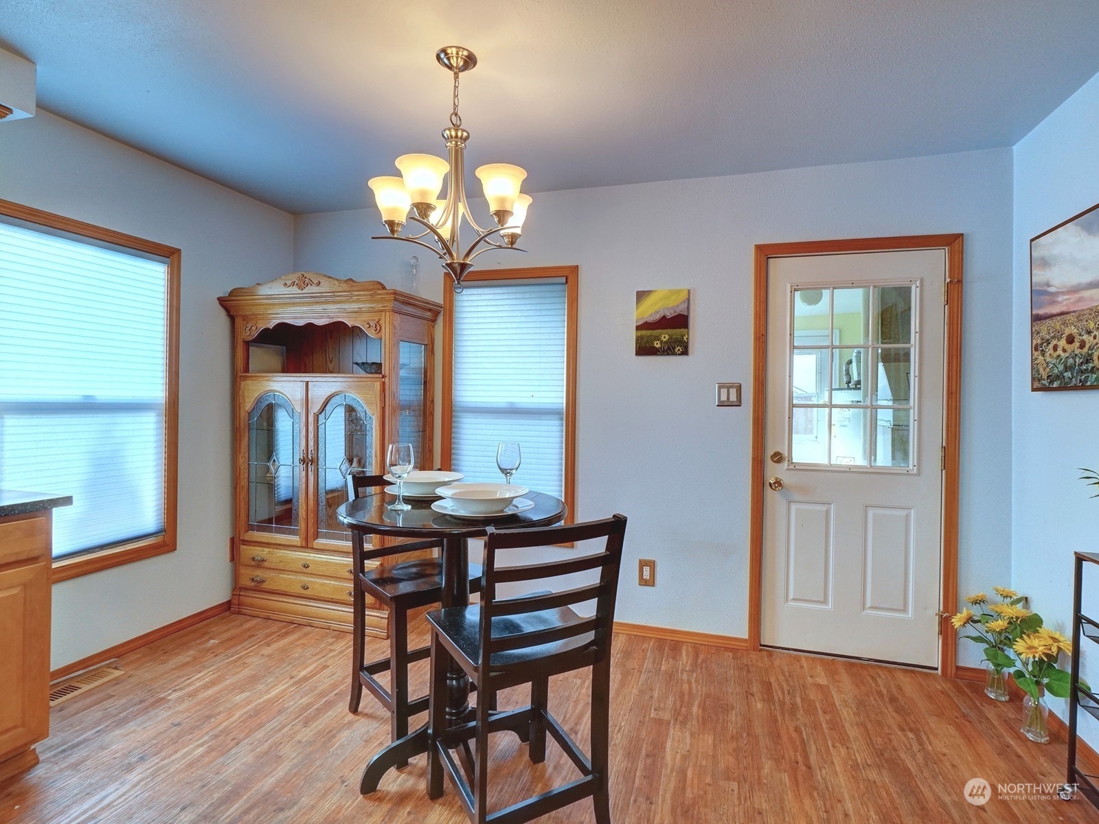 1206 Sumner Avenue Sumner, WA 98390 - Photo 12 of 30 a view of a dining room with furniture wooden floor and chandelier
