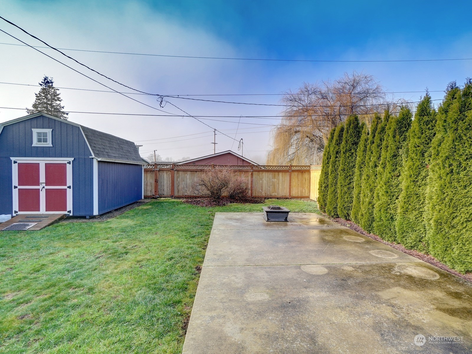 1206 Sumner Avenue Sumner, WA 98390 - Photo 26 of 30 a view of a backyard with plants and brick wall