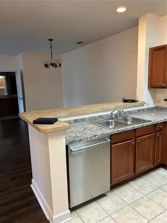 a kitchen with granite countertop cabinets stainless steel appliances and a sink