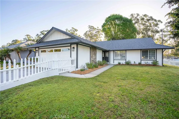 a view of a house with a yard and a garden