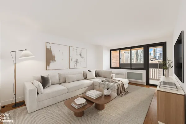 a living room with furniture and a large window with outer view