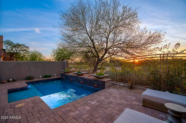 a backyard of a house with table and chairs