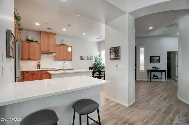 a large kitchen with a table and chairs