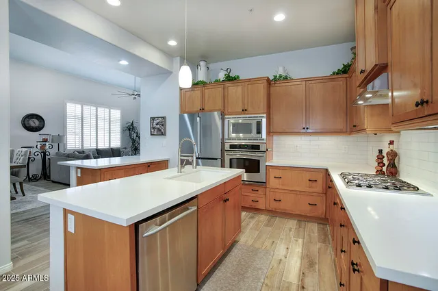 a kitchen with a sink appliances and cabinets