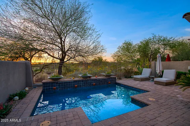 a view of a backyard with sitting area