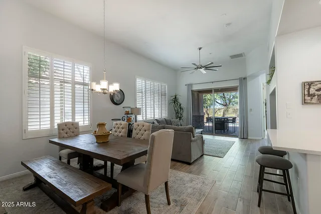 a living room with furniture a chandelier and a table