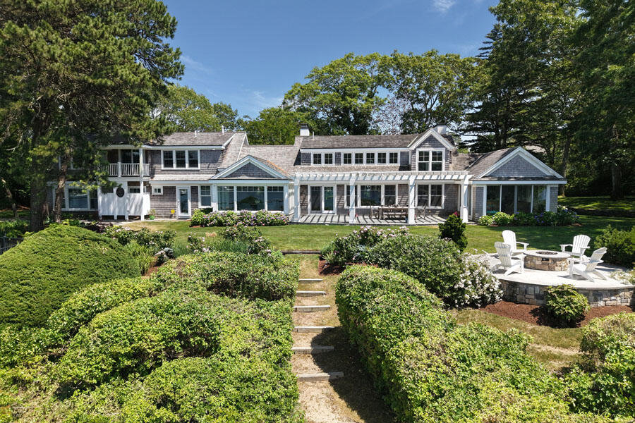 71 Sand Point Osterville, MA 02655 - Photo 40 of 45 a front view of a house with a yard table and chairs