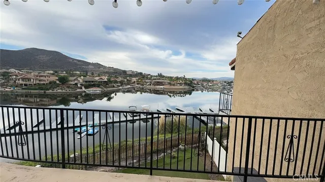 a bathroom with a granite countertop toilet and a sink