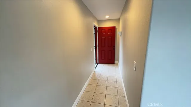 an empty room with a window and a ceiling fan