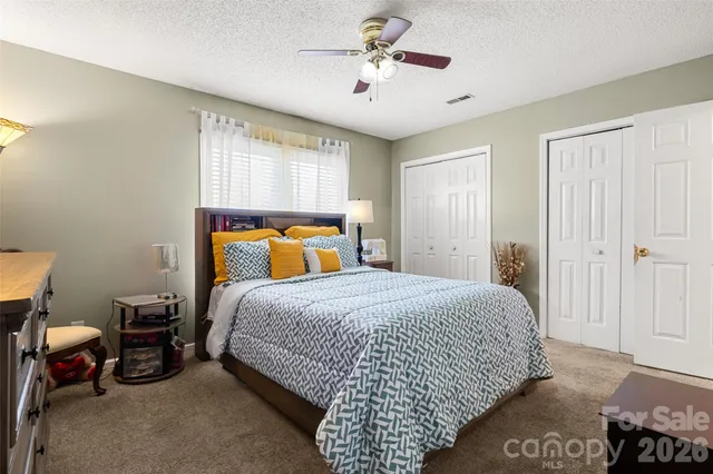 a bedroom with a bed a lamp and a window